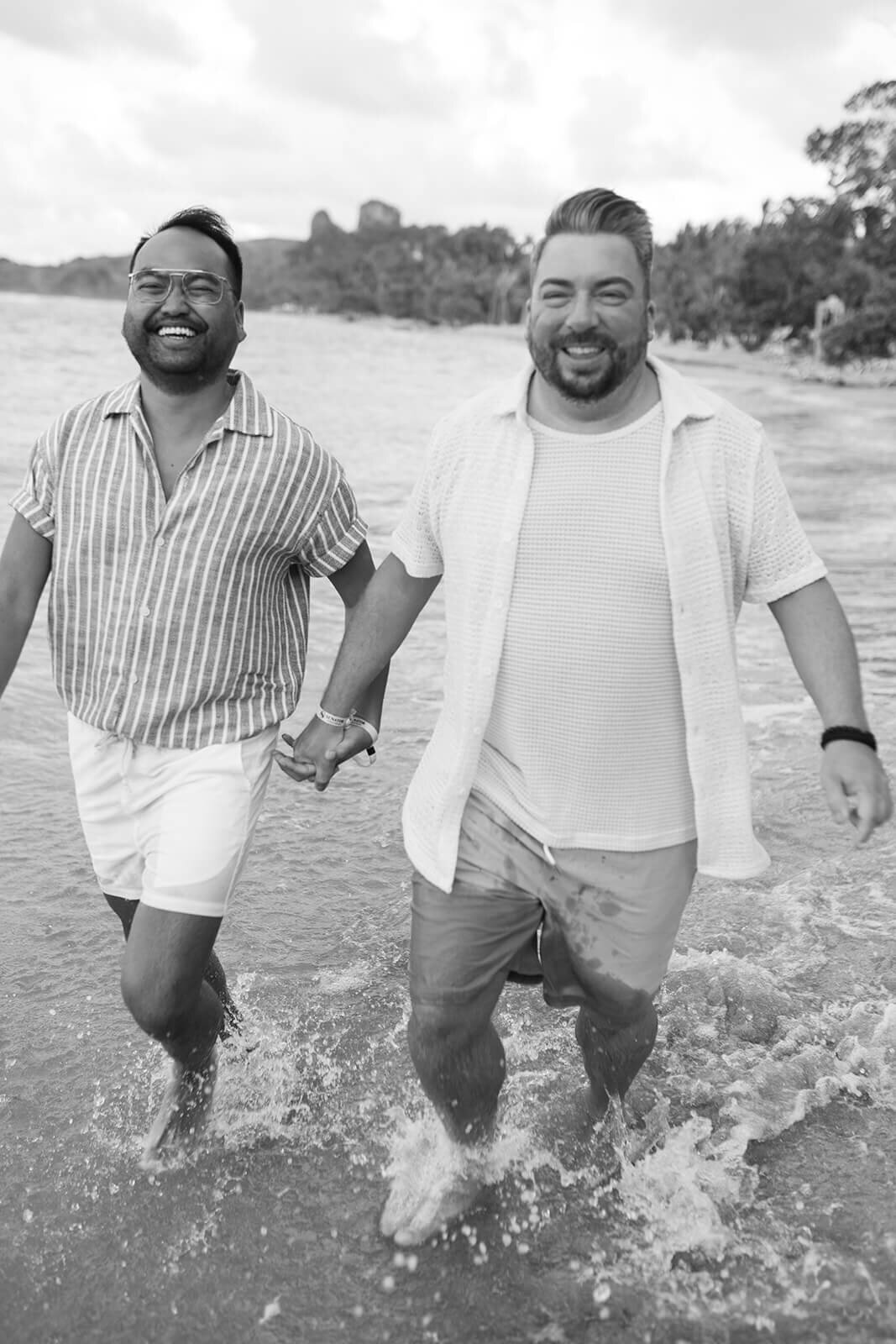 Couple-running-in-water-on-beach