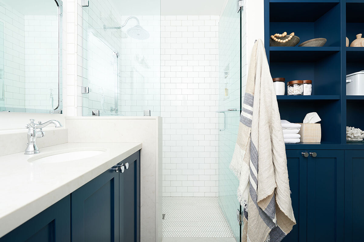 bathroom with navy blue cabinets