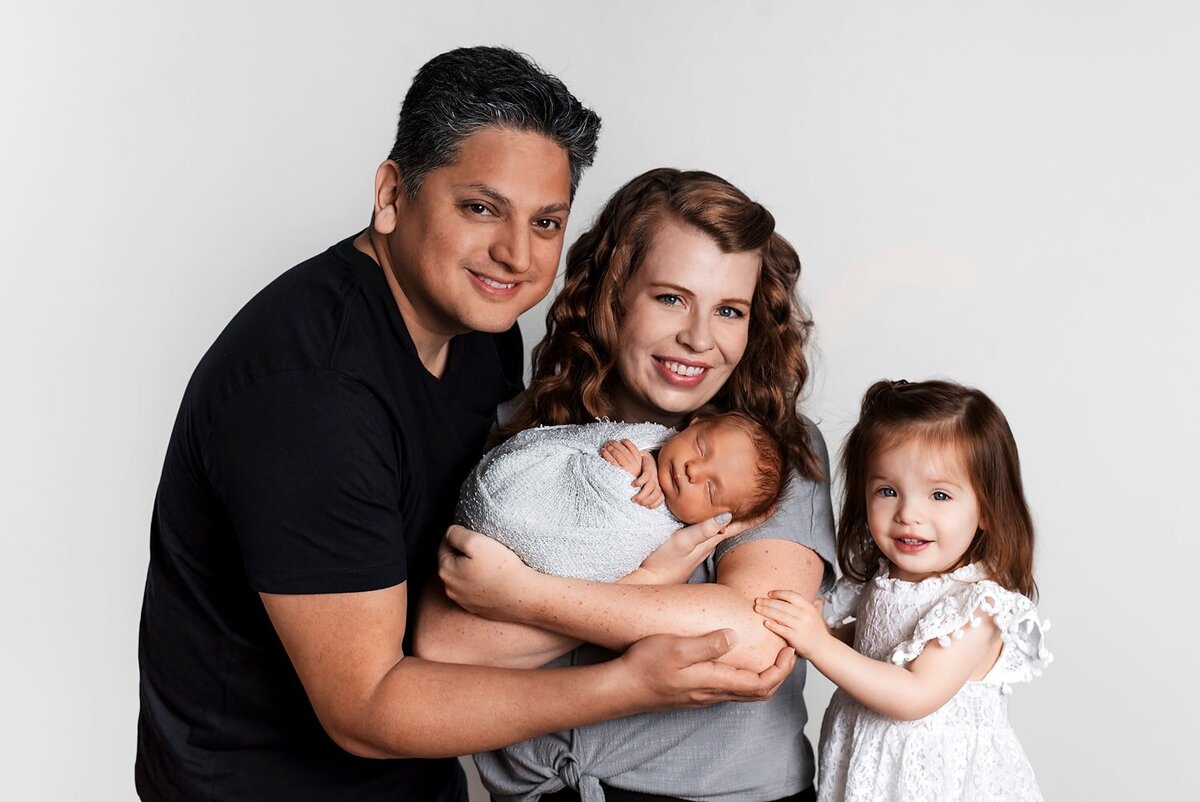 Father, mother, toddler sister and newborn boy family portraits