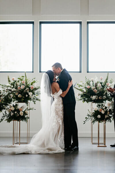 Bride and groom kissing at wedding by wedding planners chicago