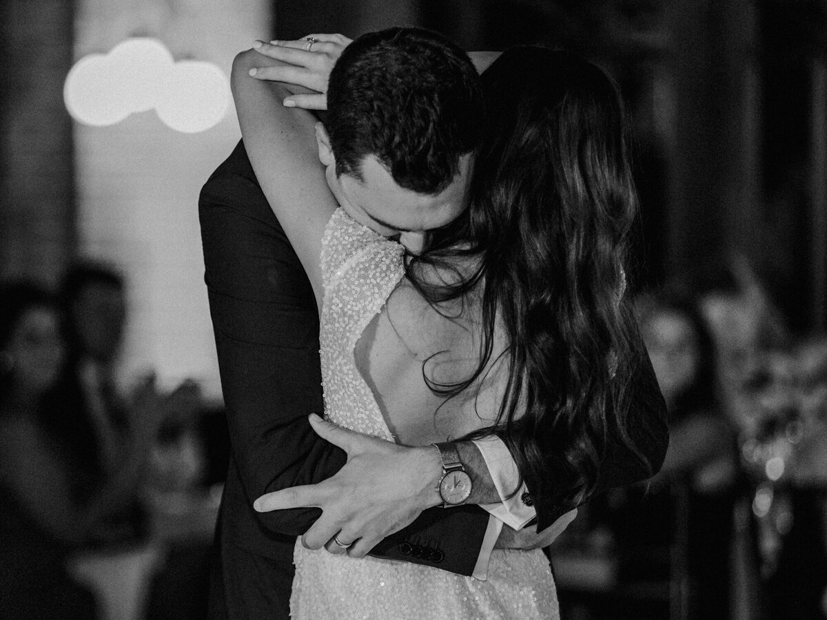 Newlyweds embrace in an emotional moment captured during their first dance at their wedding reception at Cafe Brauer in Chicago