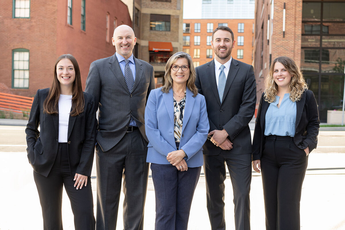 Team-photo-of-five-in-urban-setting