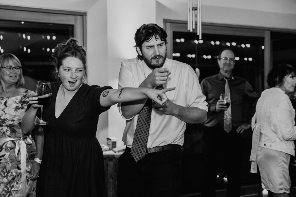 Wedding guests dancing energetically outdoors