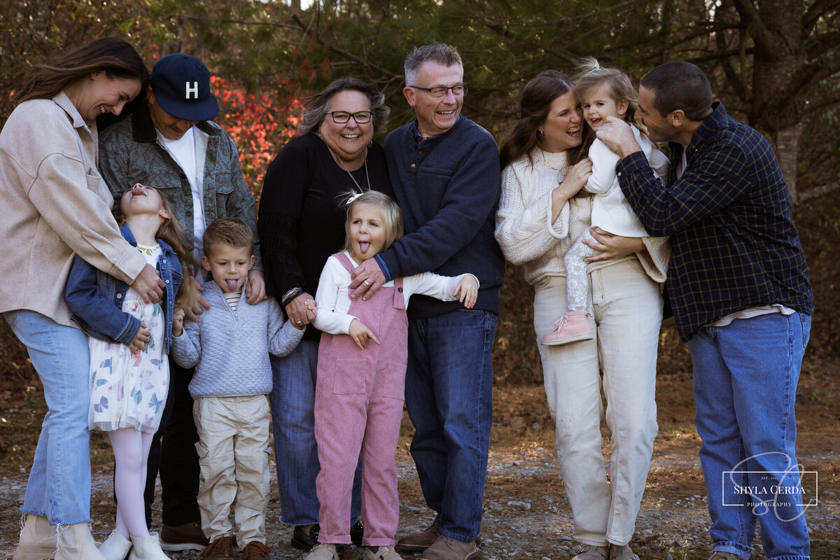 Family laughing and playing in fall