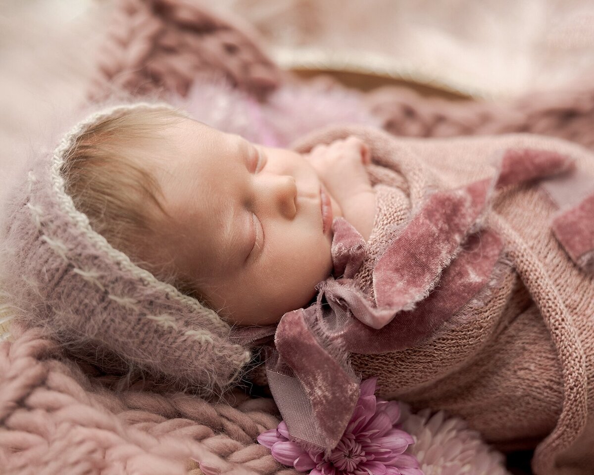 Pink bonnet on baby girl for newborn pictures in porland studio