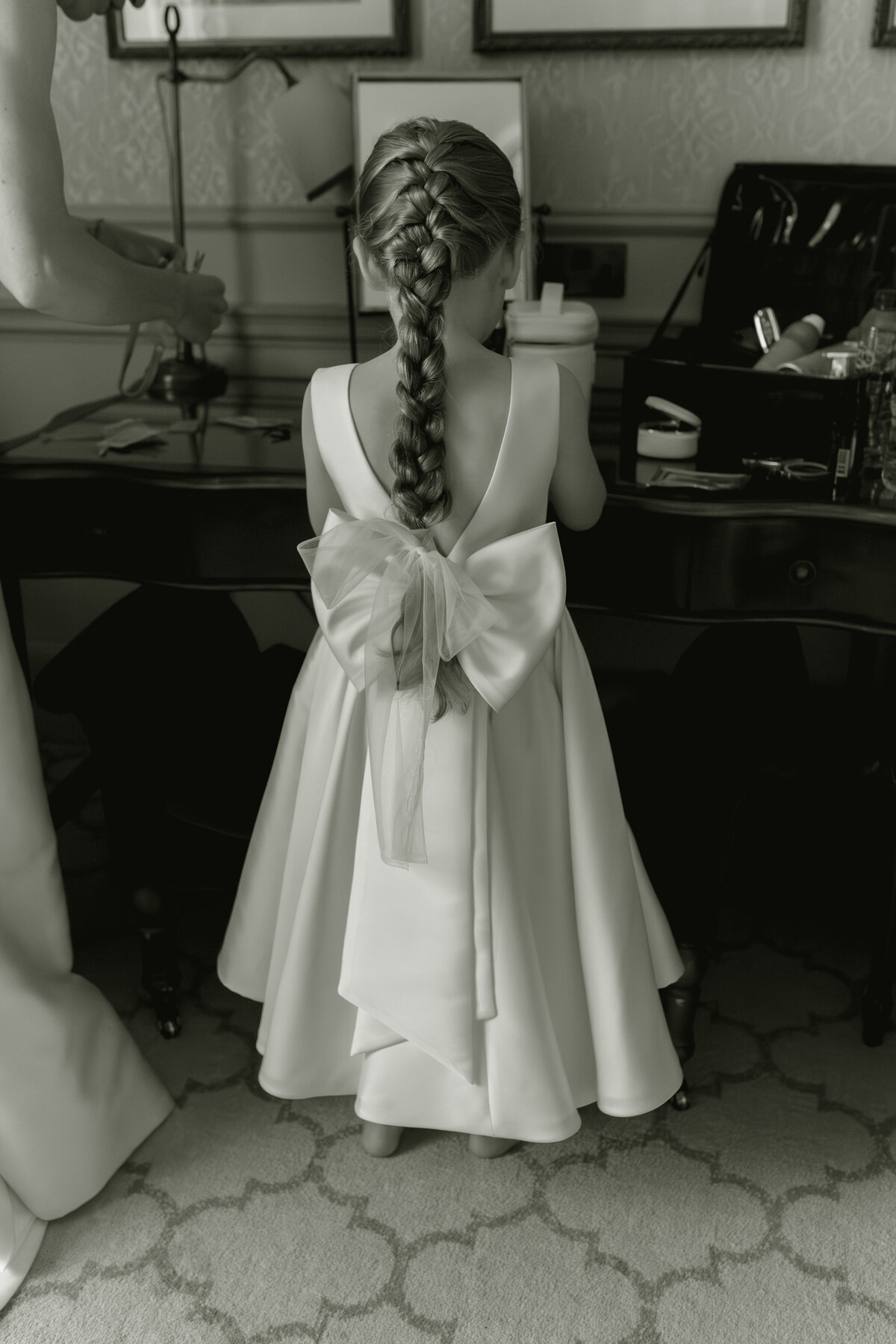Flower girl with large bow on back of her dress.  Image by Gleneagles wedding photographer, Jill Cherry Porter.
