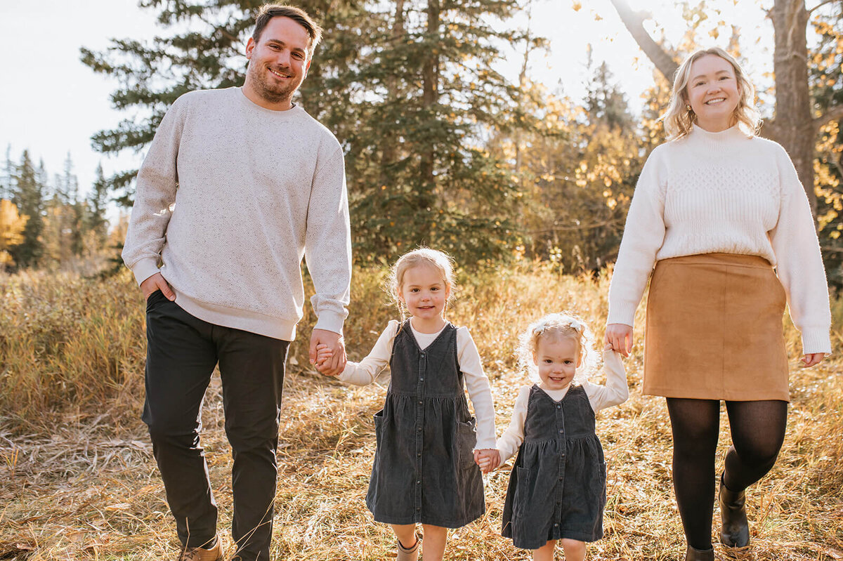 Parents-holding-hands-with-young-daughters