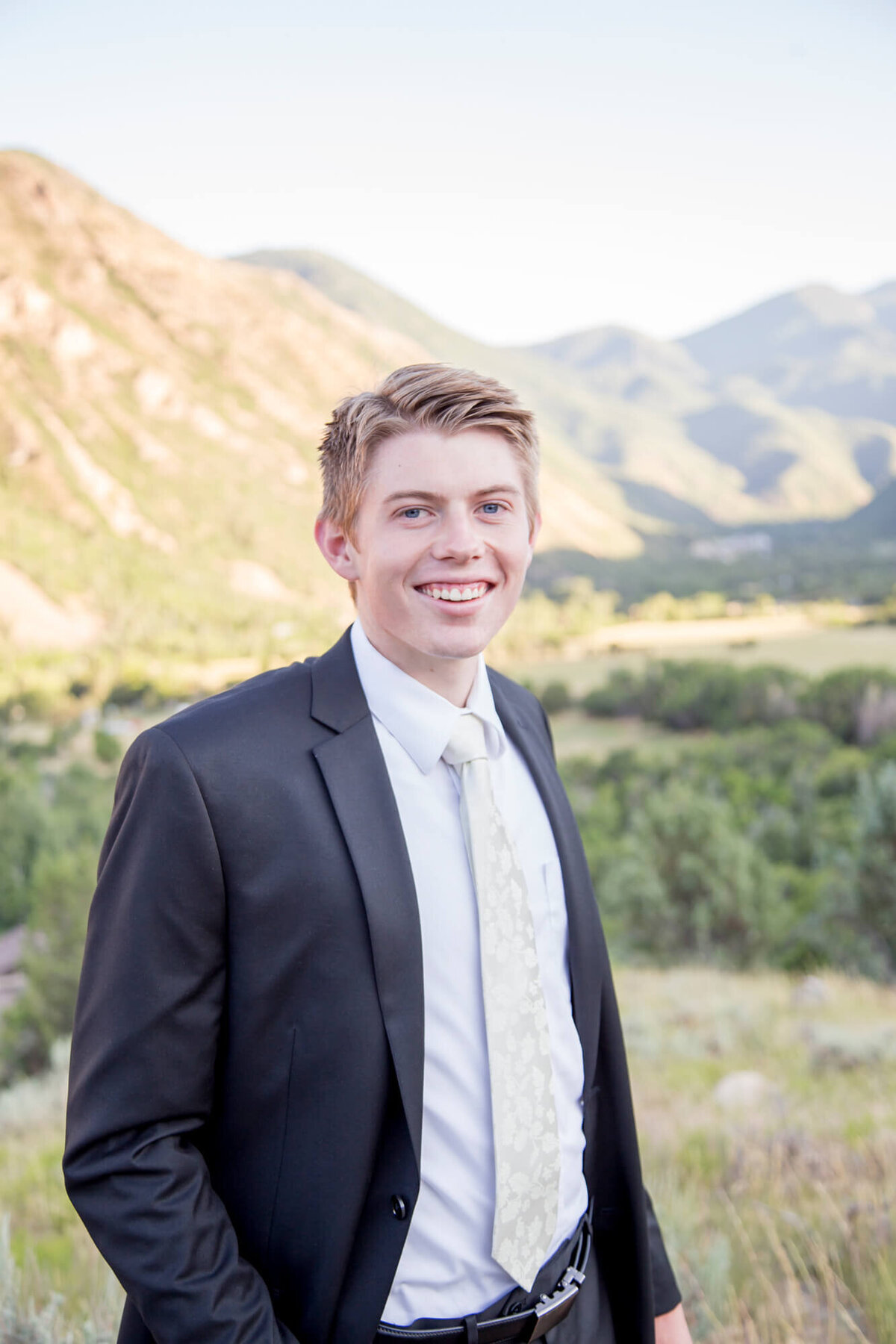 portrait of a groom in the mountains