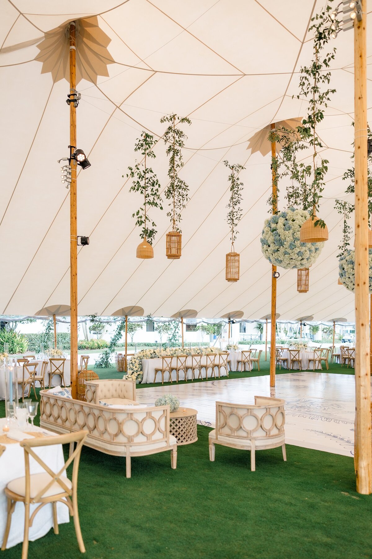 Sperry Tent decor with custom floor wrap and blue floral decor on a golf course