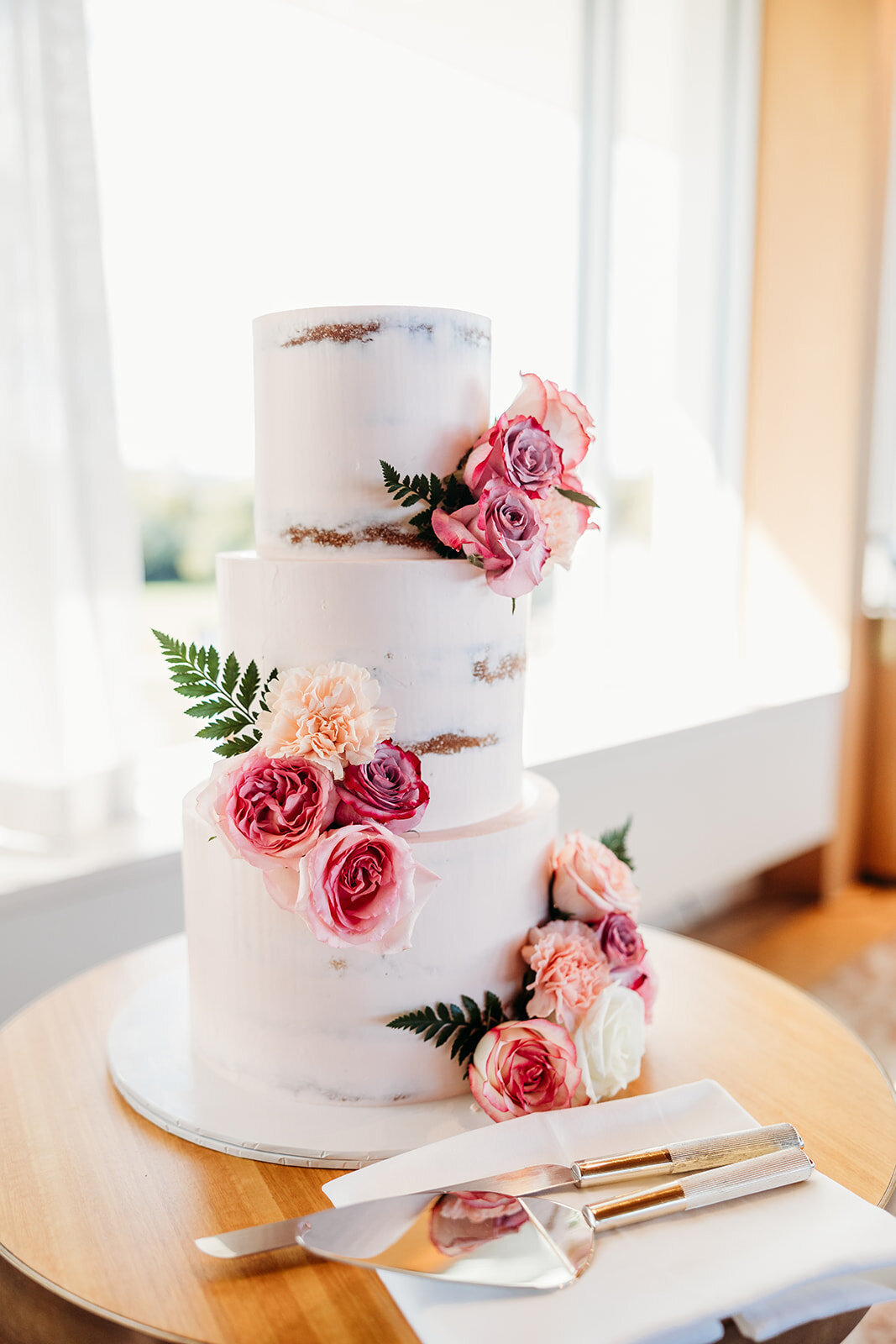 Wedding cake with pink flowers at The Marion. Captured by Acacia & Grace Photography