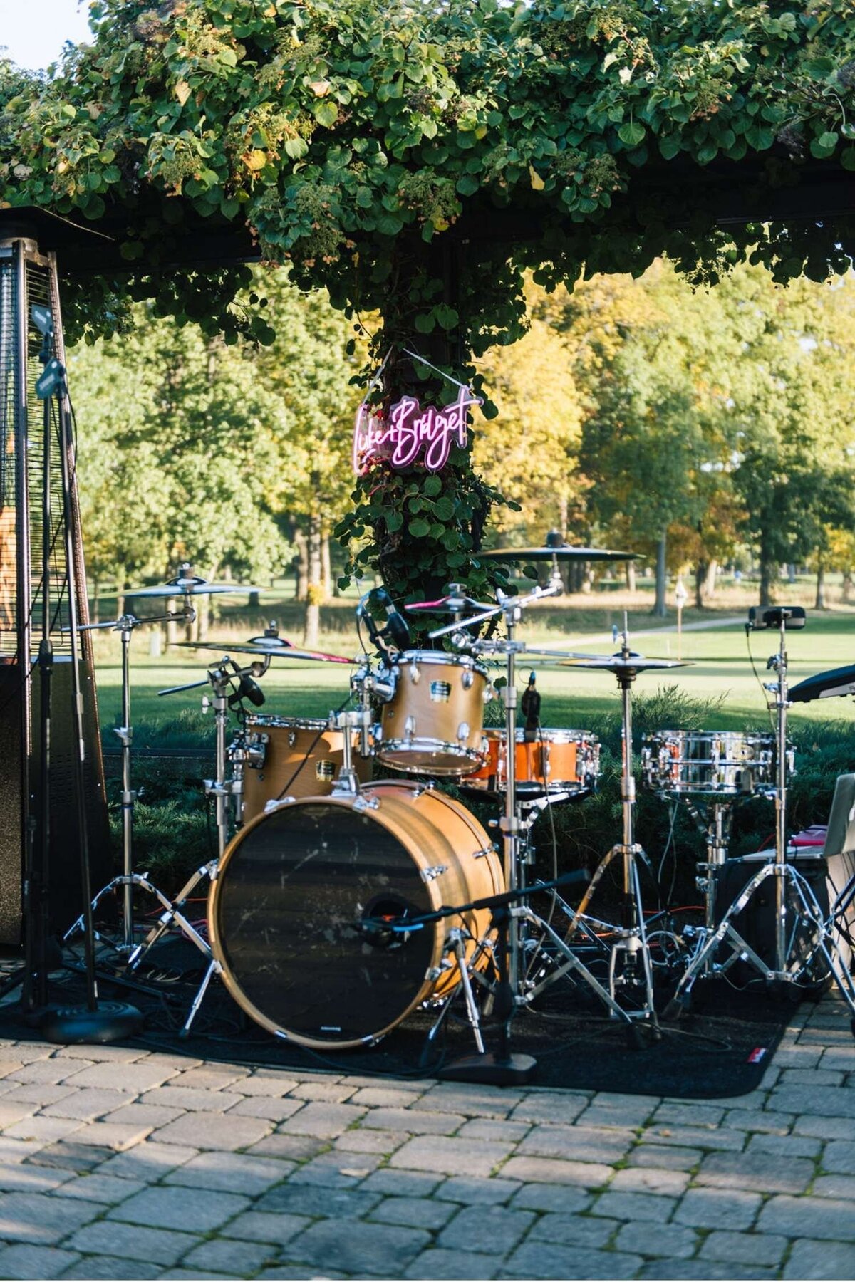 Reception Band Sets Up on the Outdoor Patio of a Tented Luxury Michigan Lakefront Golf Club Wedding.