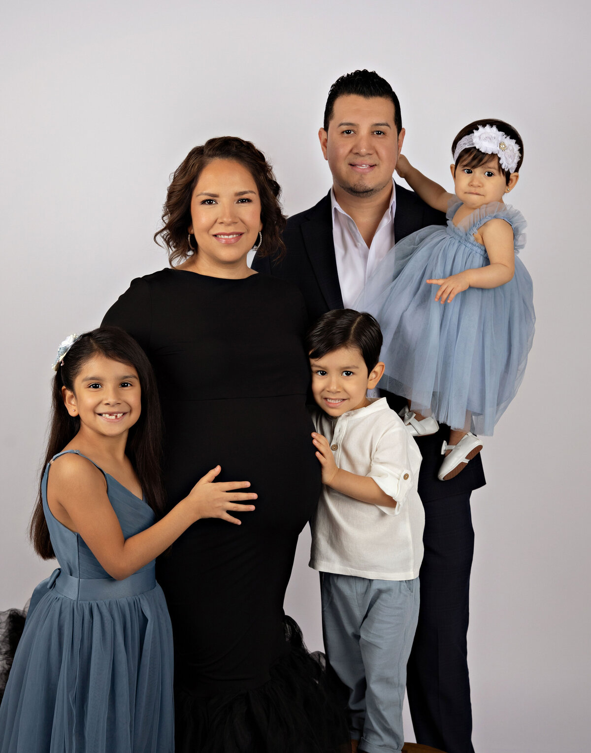 beautiful family using our client closet gown during maternity photoshoot in best san antonio texas photography studio 