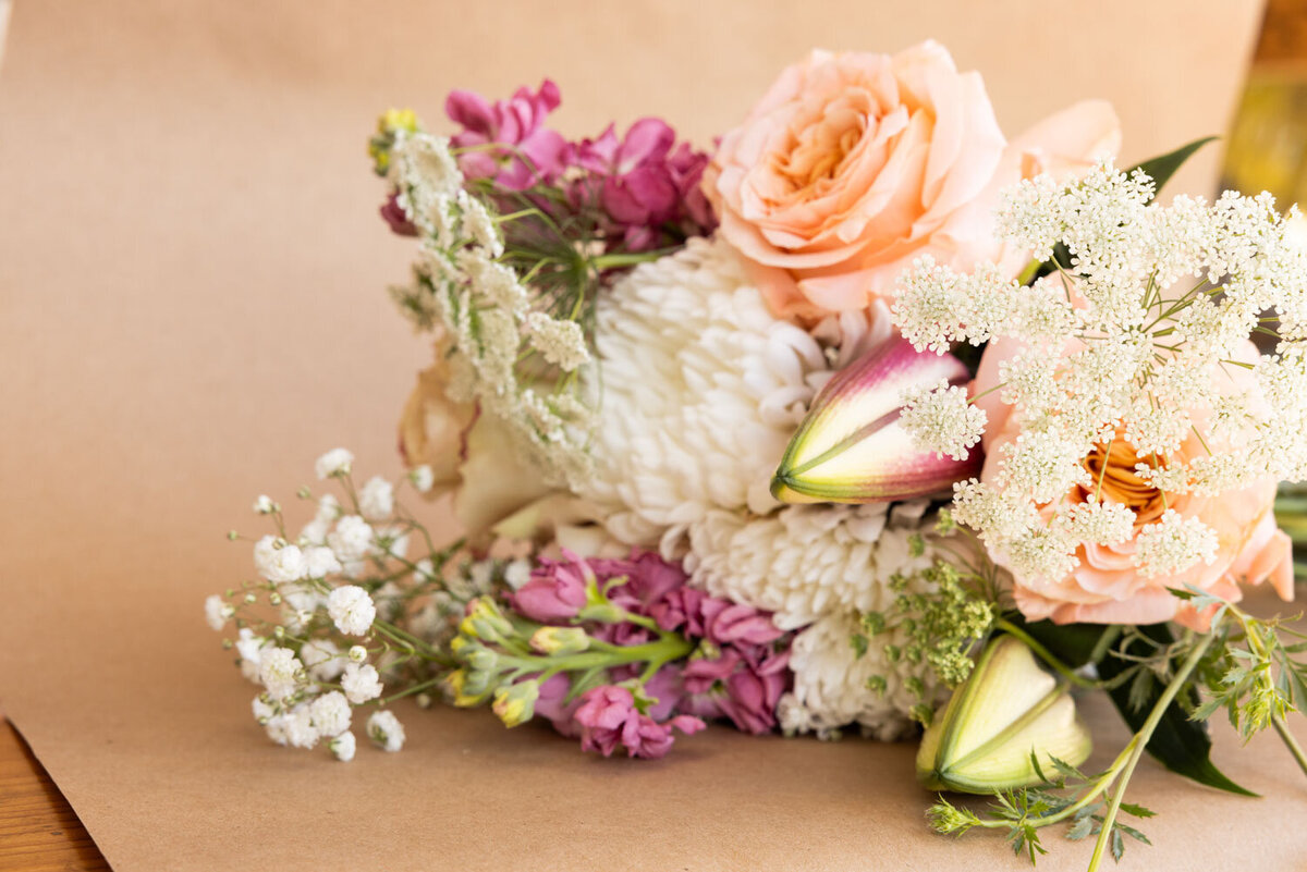 Soft-toned bouquet with pink and white flowers on craft paper