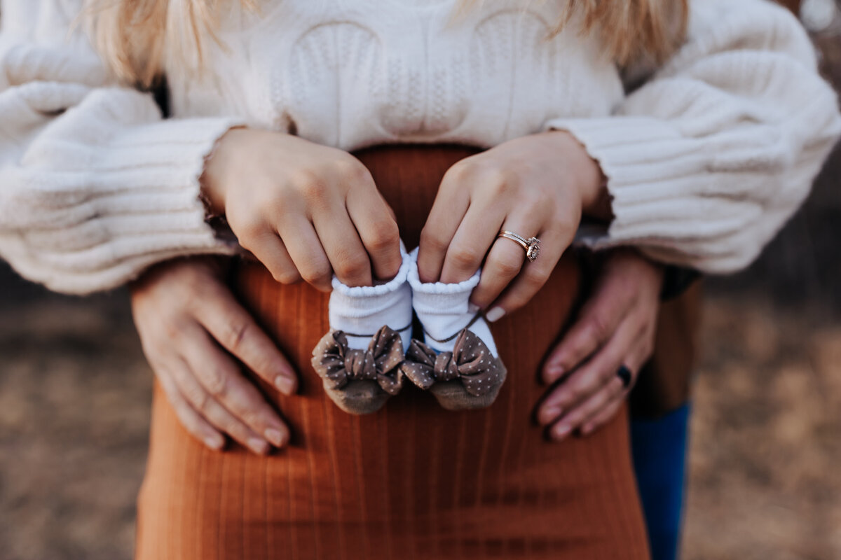 Nashville newborn photographer captures mother holding shoes