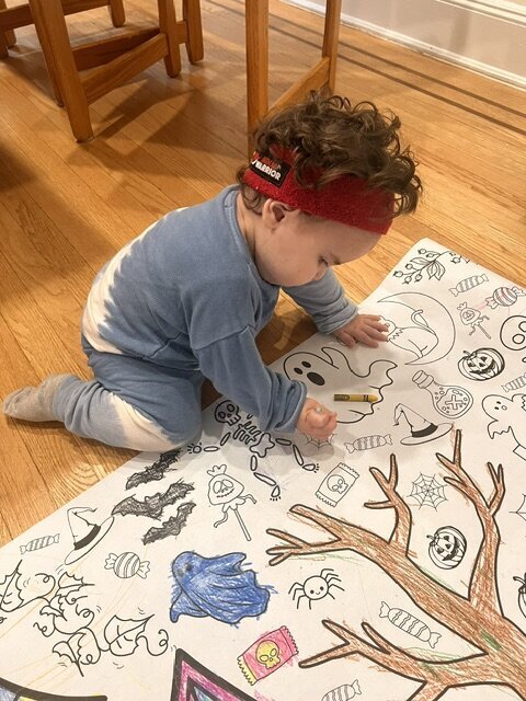 little boy coloring halloween banner