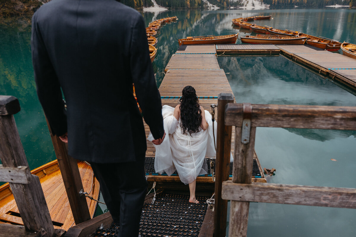 Lago di Braies sunrise elopement couple on La Palifitta dock