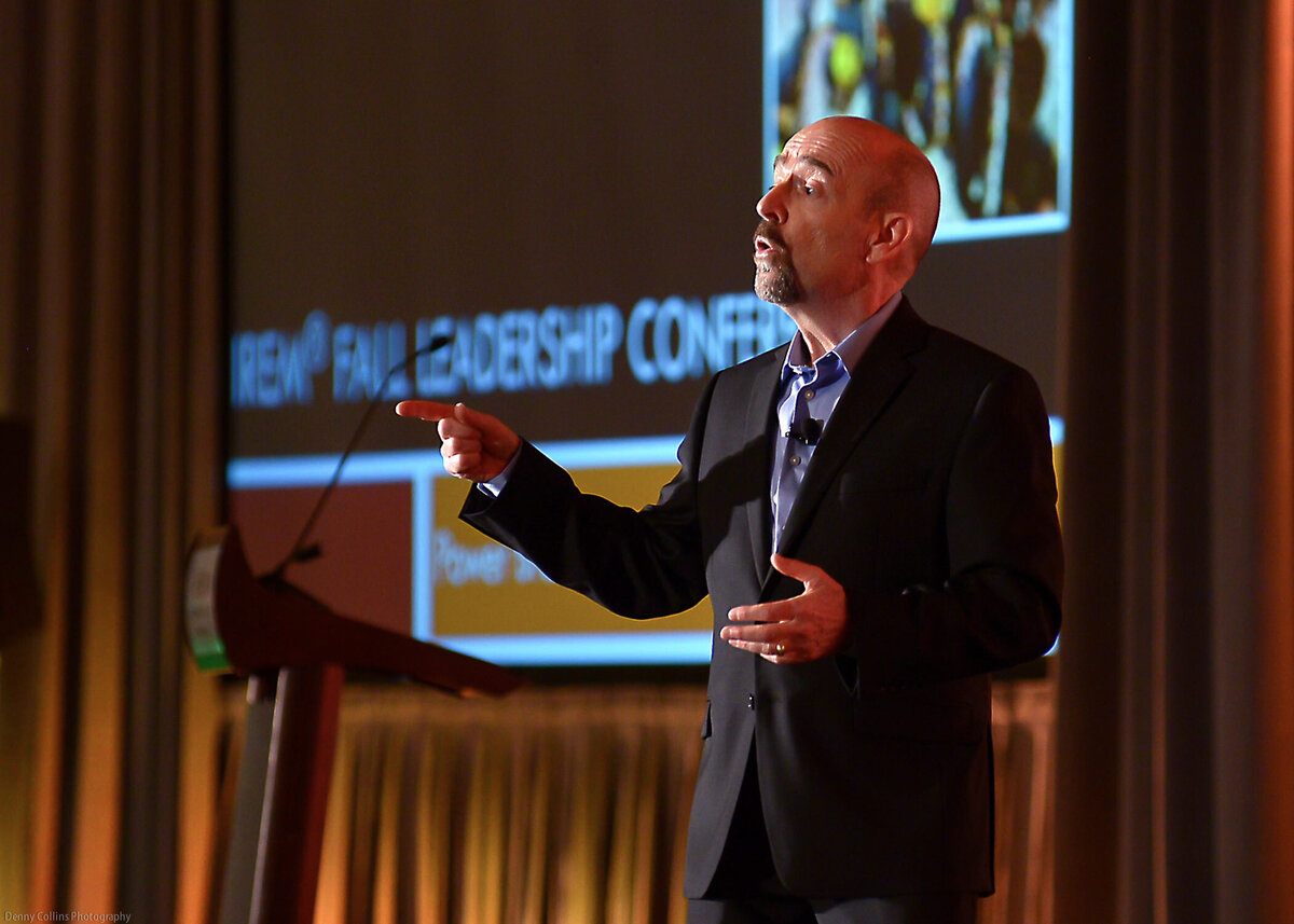 Motivational speaker, Steve Rizzo, on stage at an event