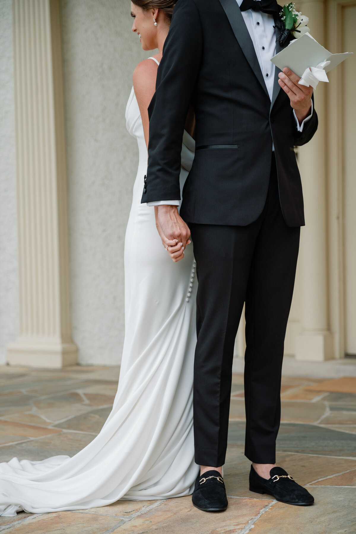 Bride and groom holding hands at Rust Manor House