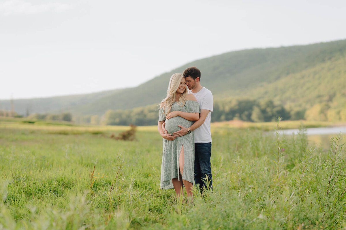 Couple hugging at  maternity session in Finger Lakes, New York