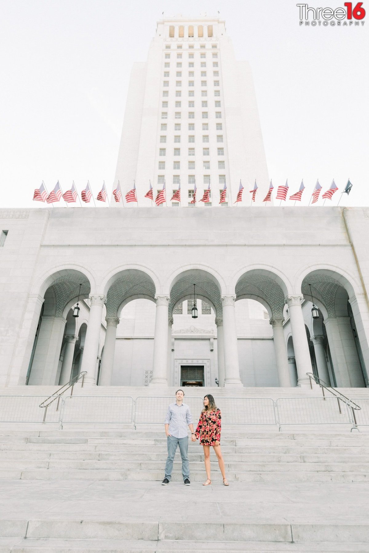 Bride to be looks at her Groom as they hold hands on the Los Angeles City Hall steps