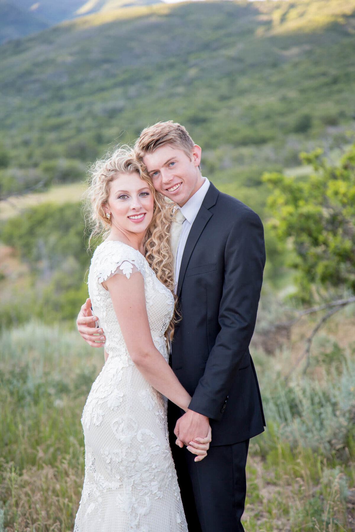 a bride and groom in the mountains