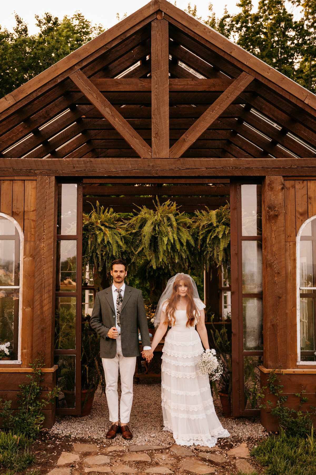Bride and groom stand at the alter night after the elopement ceremony is complete. Greenhouse on Strawberry Lane | Nova Scotia