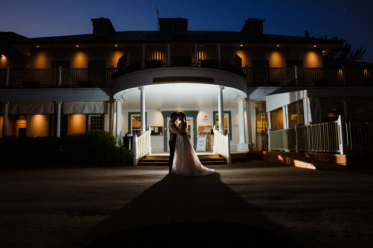 dramatic night wedding portrait in front of the manoir montmorency