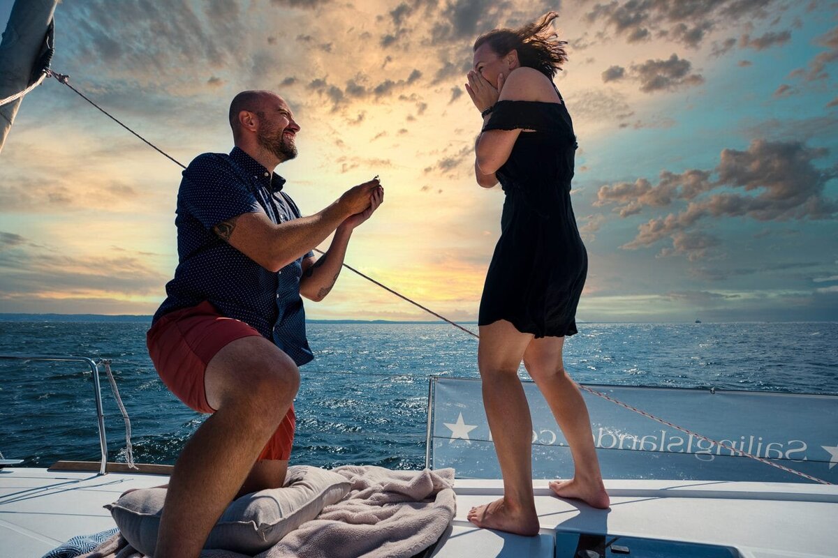 Man proposing to a woman on a boat in the water
