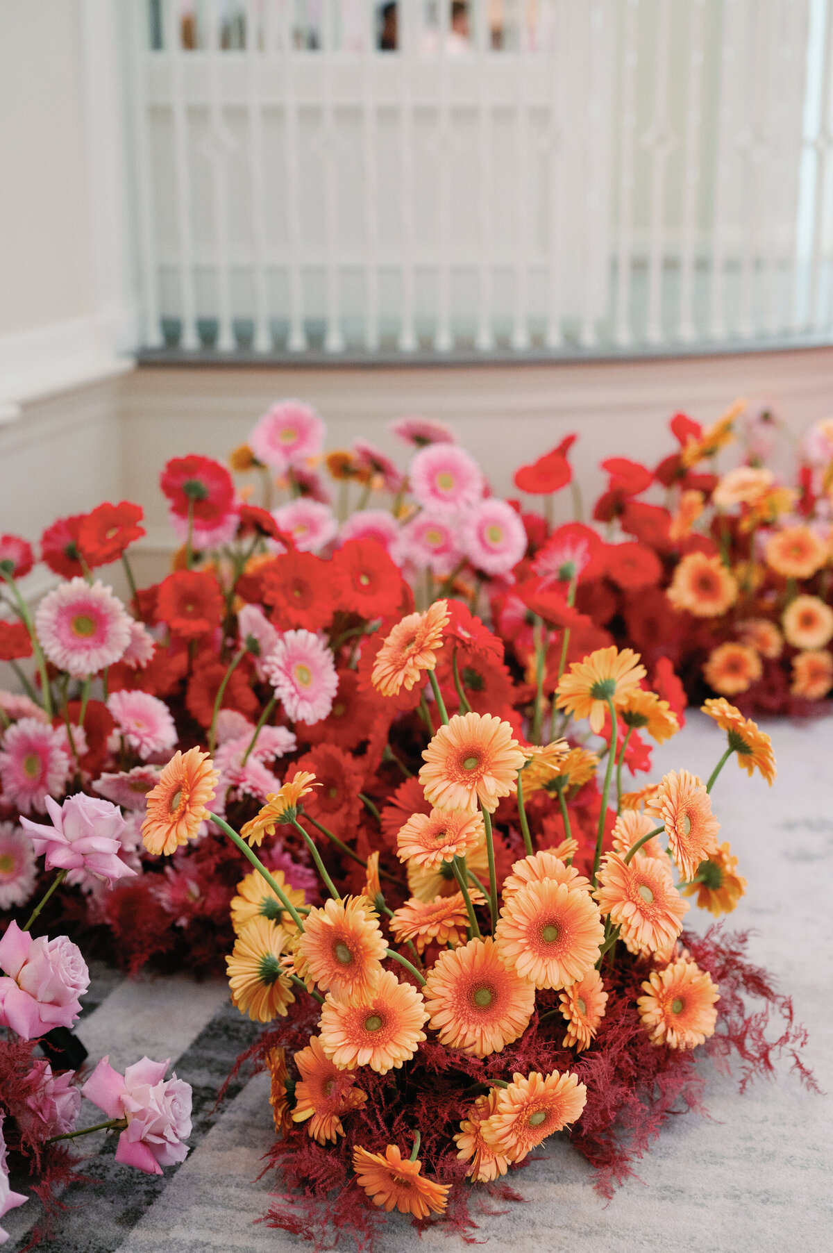  Stunning floral arrangement featuring vibrant red and yellow blooms, creating a bold and elegant display, designed by In Full Bloom Event Planning & Design.