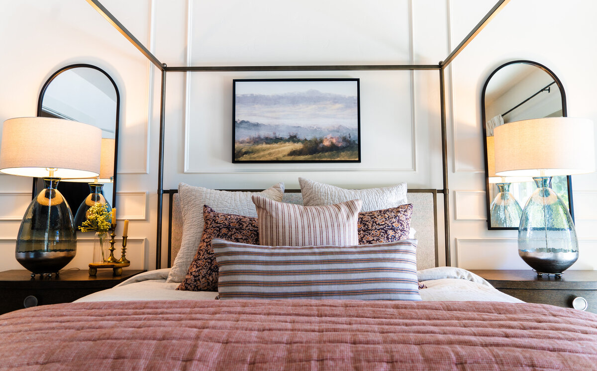 luxury bedroom with white dresser white sitting chiar and bed with blue blanket