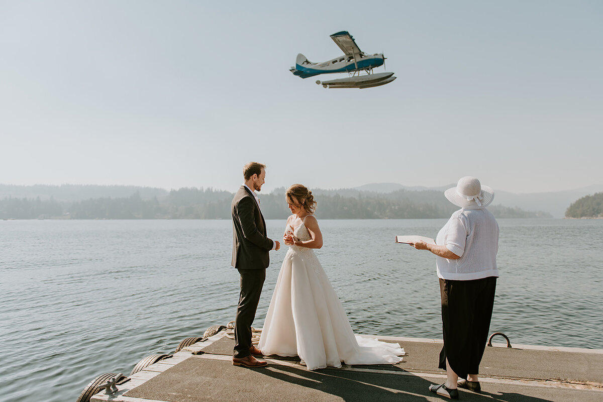 Couple popping champagne in celebration during their Sunshine Coast B.C Mountain Elopement