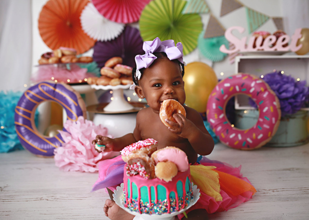baby girl celebrating first birthday donuts