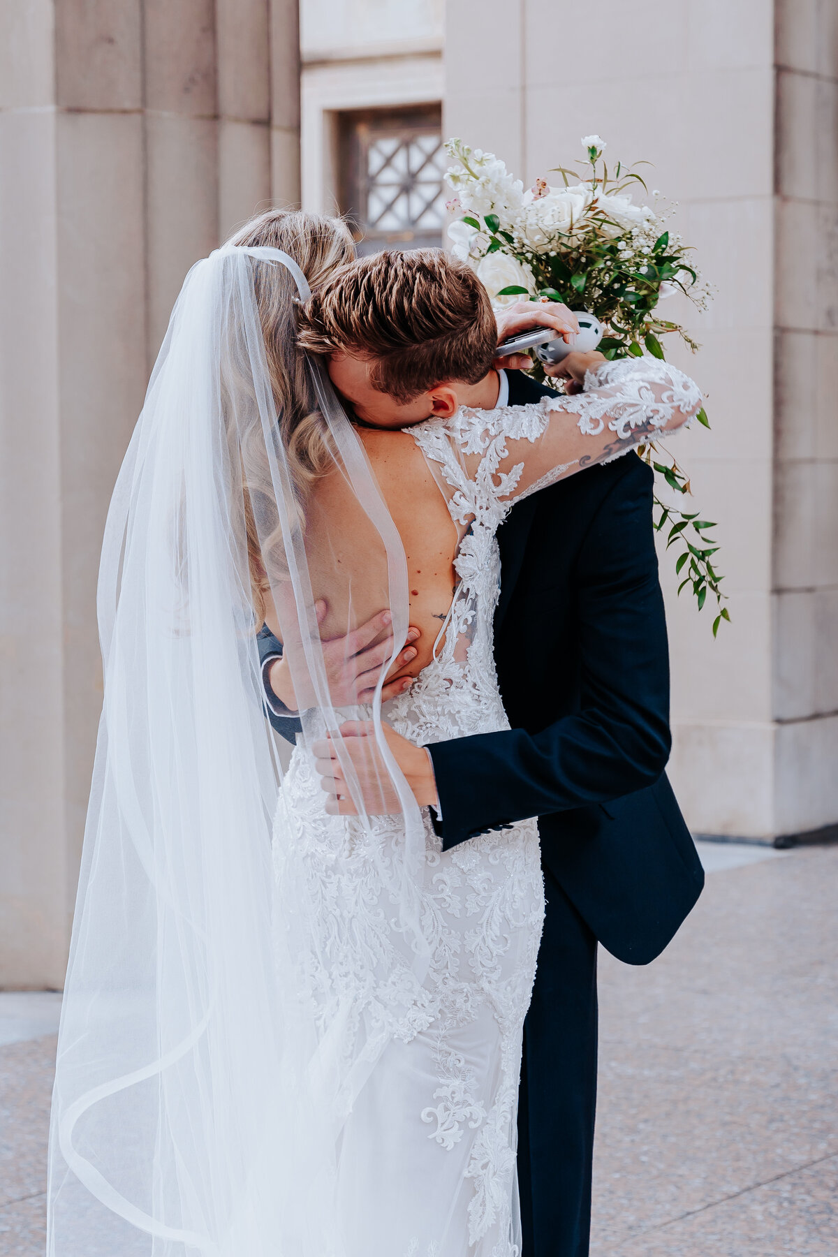 Nashville wedding photographer captures groom hugging bride after first look