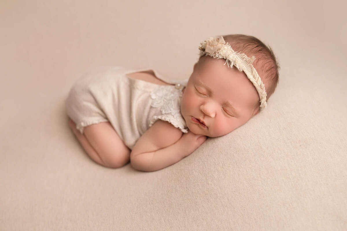 baby girl on white backdrop during photography session