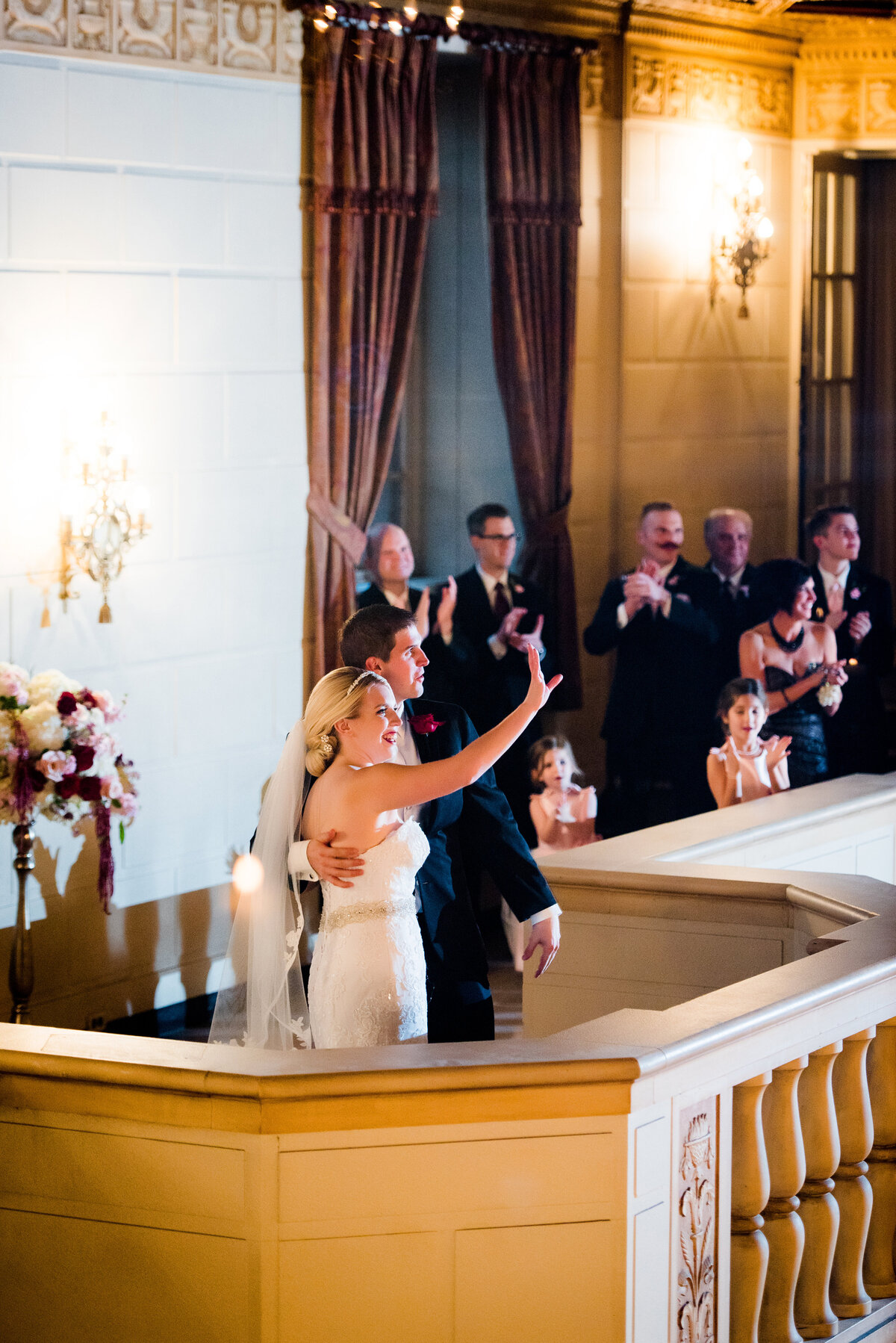 couple waving to guests