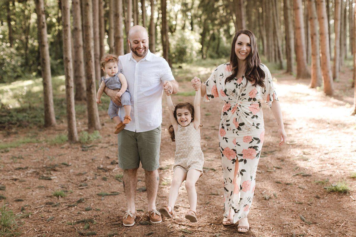 family walking through trees, natural light family portraits
