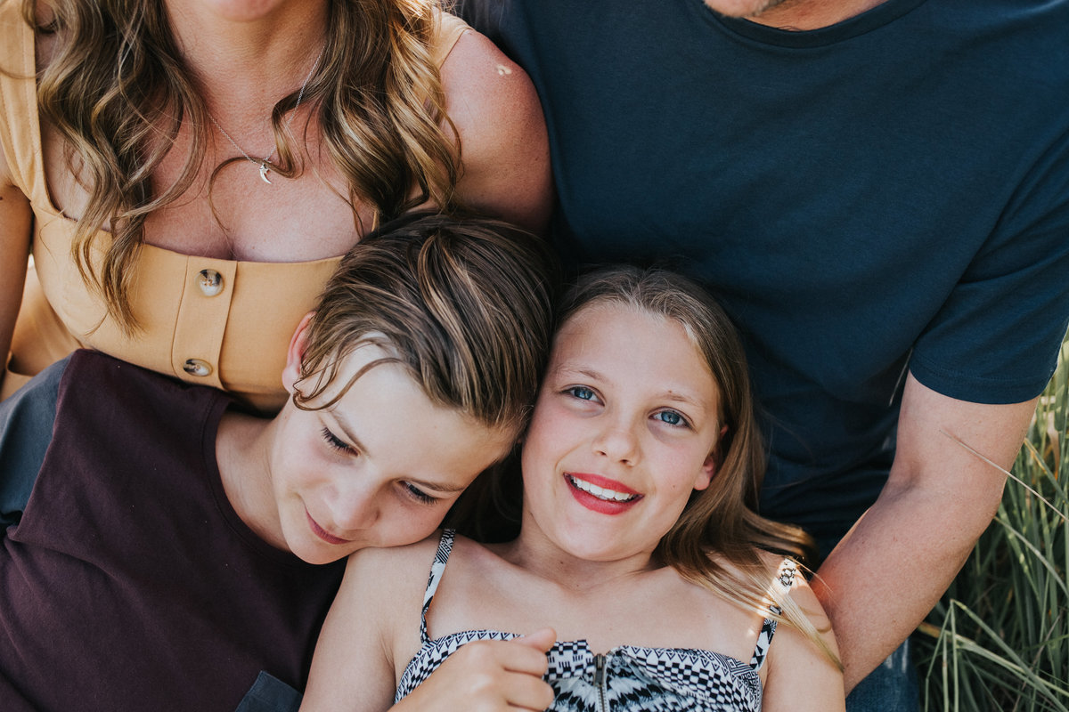 Family photo in long grassy field at sunset in Yarra Glen. Melbourne Family Photographer. Sapphire and Stone Photographer