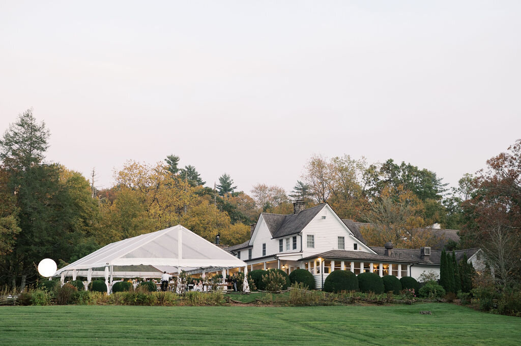 Black and white sparkler exit moment with the couple kissing at the bottom of the staircase at Old Edwards Inn.