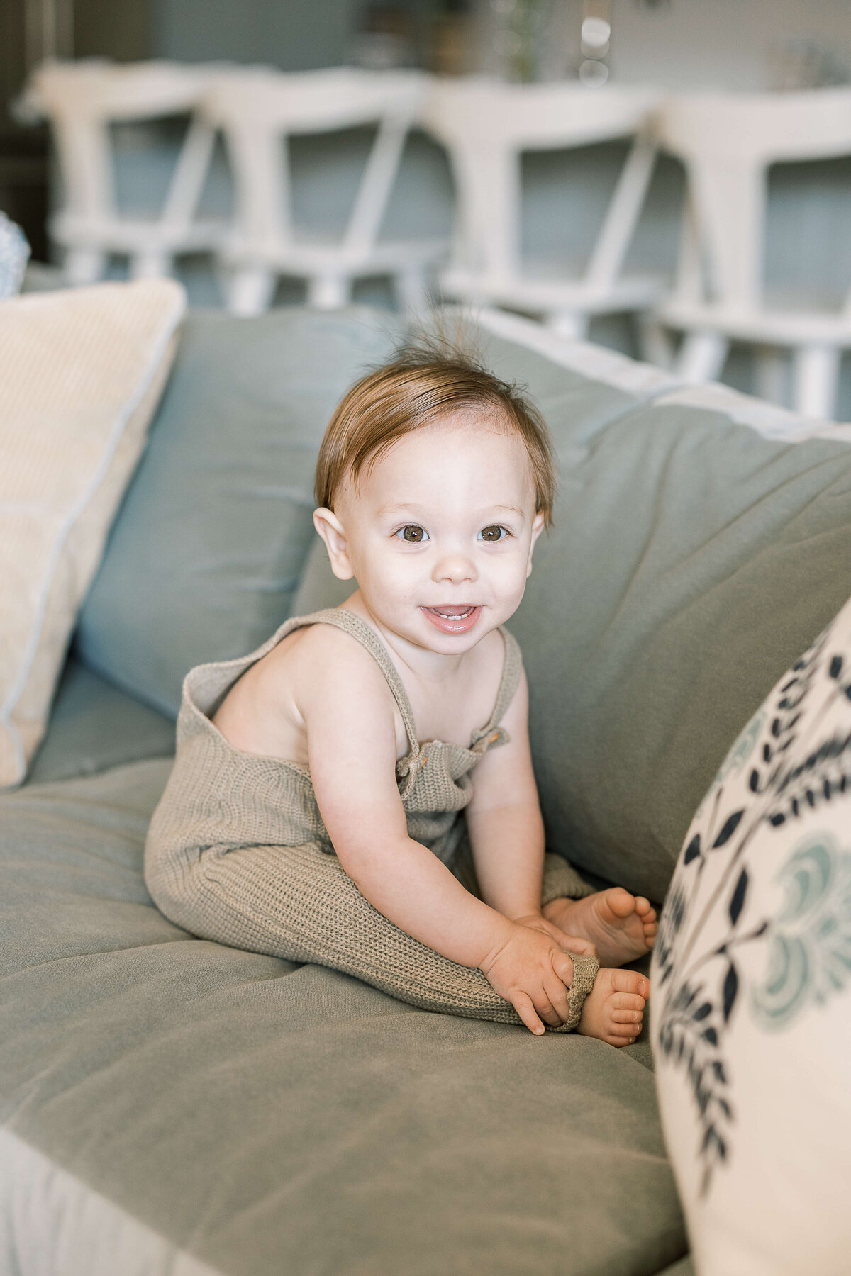 a baby sitting on a couch