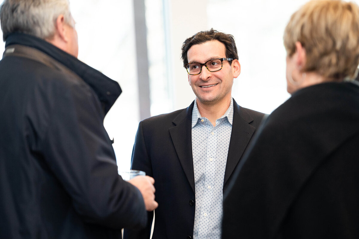 the eQ team mingling and chatting with guests during the Groundbreaking event.  the host of eQ addressing and welcoming guests to the eQ Groundbreaking event.  Captured by Ottawa Event Photographer JEMMAN Photography COMMERCIAL