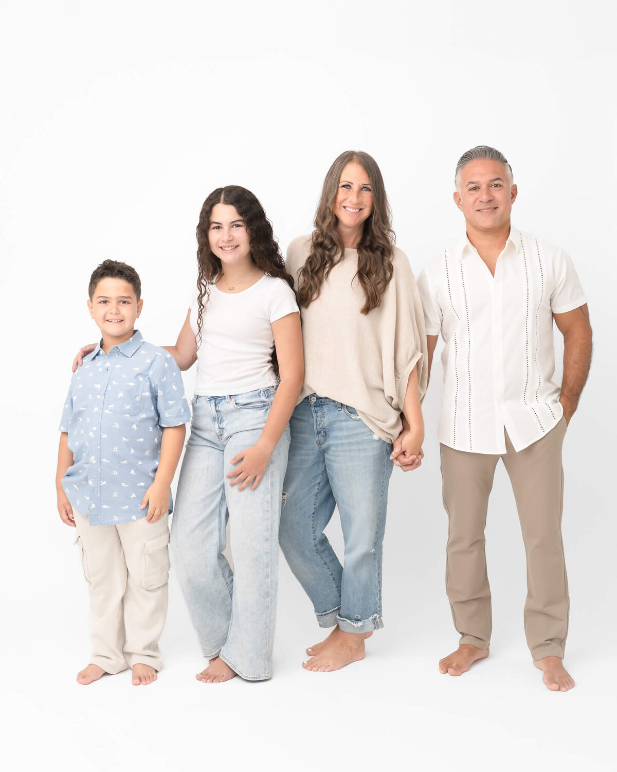 Family with bigger kids dressed in coordinating neutrals and denim in casual family studio portrait in McKinney Tx, captured by Allison Amores Photography