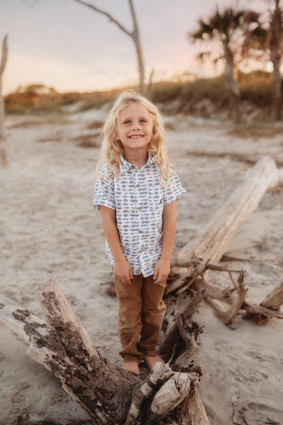 Little boy smiles at the camera during Family Pictures on Folly Beach.