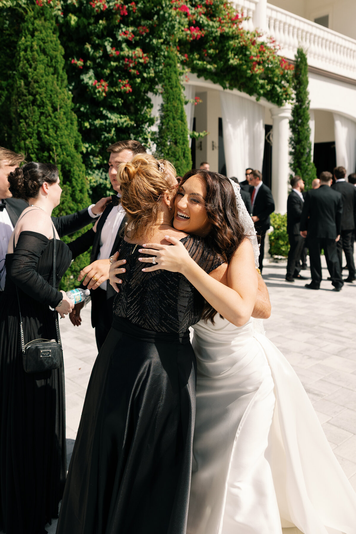 Candid hugs during cocktail hour at La Casa Toscana Wedding Venue Fort Myers Florida