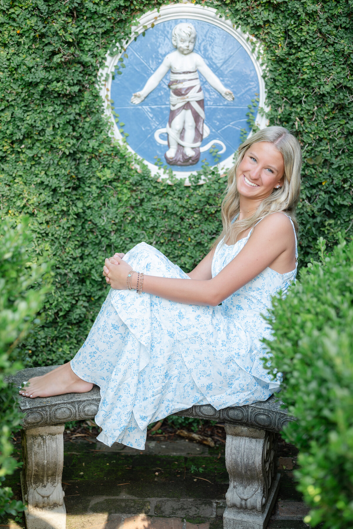 Senior portrait sitting in a garden in Tallahassee by Photography by LV Hughes. Serving Tallahassee, Bainbridge, & surrounding areas. 