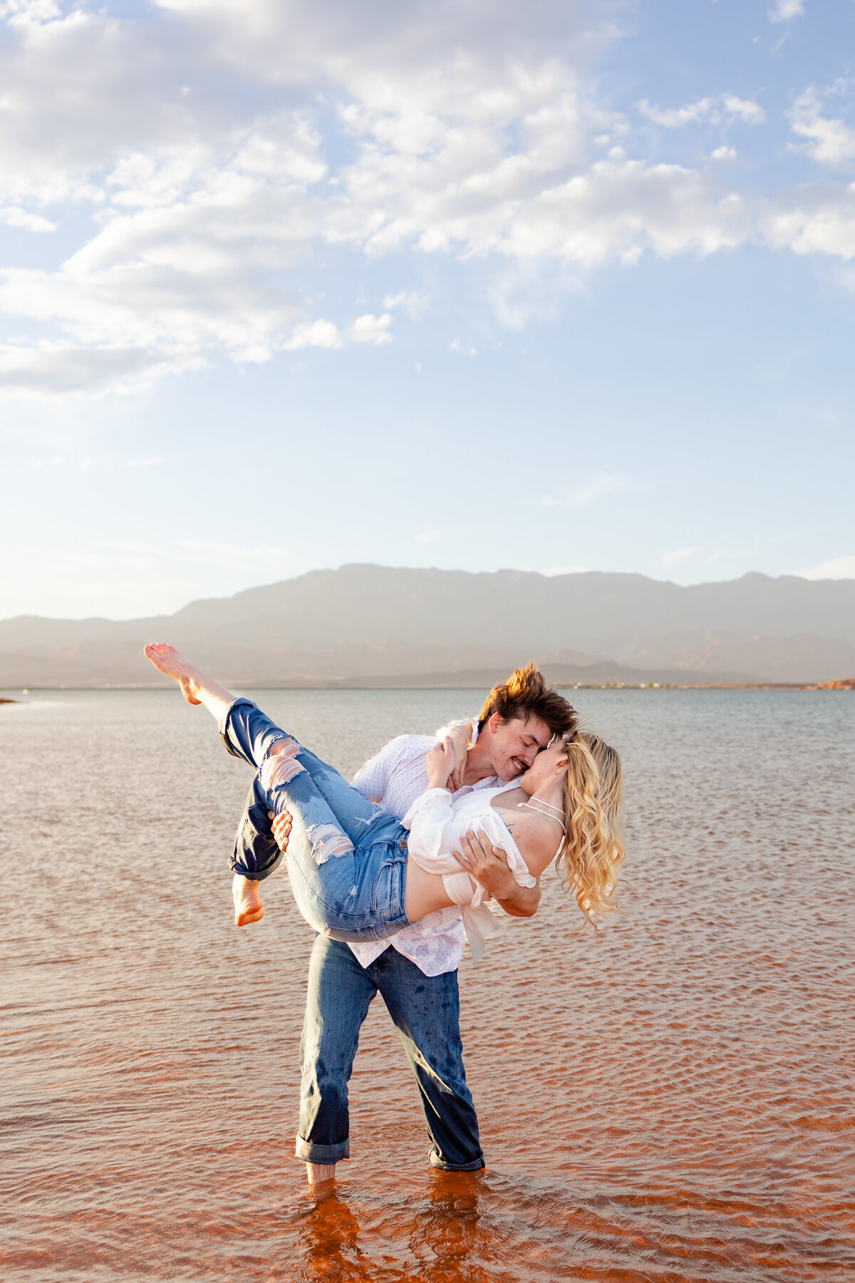 Young women being held up by her fiance in the waters of Sand Hollow Reservoir in St George Utah