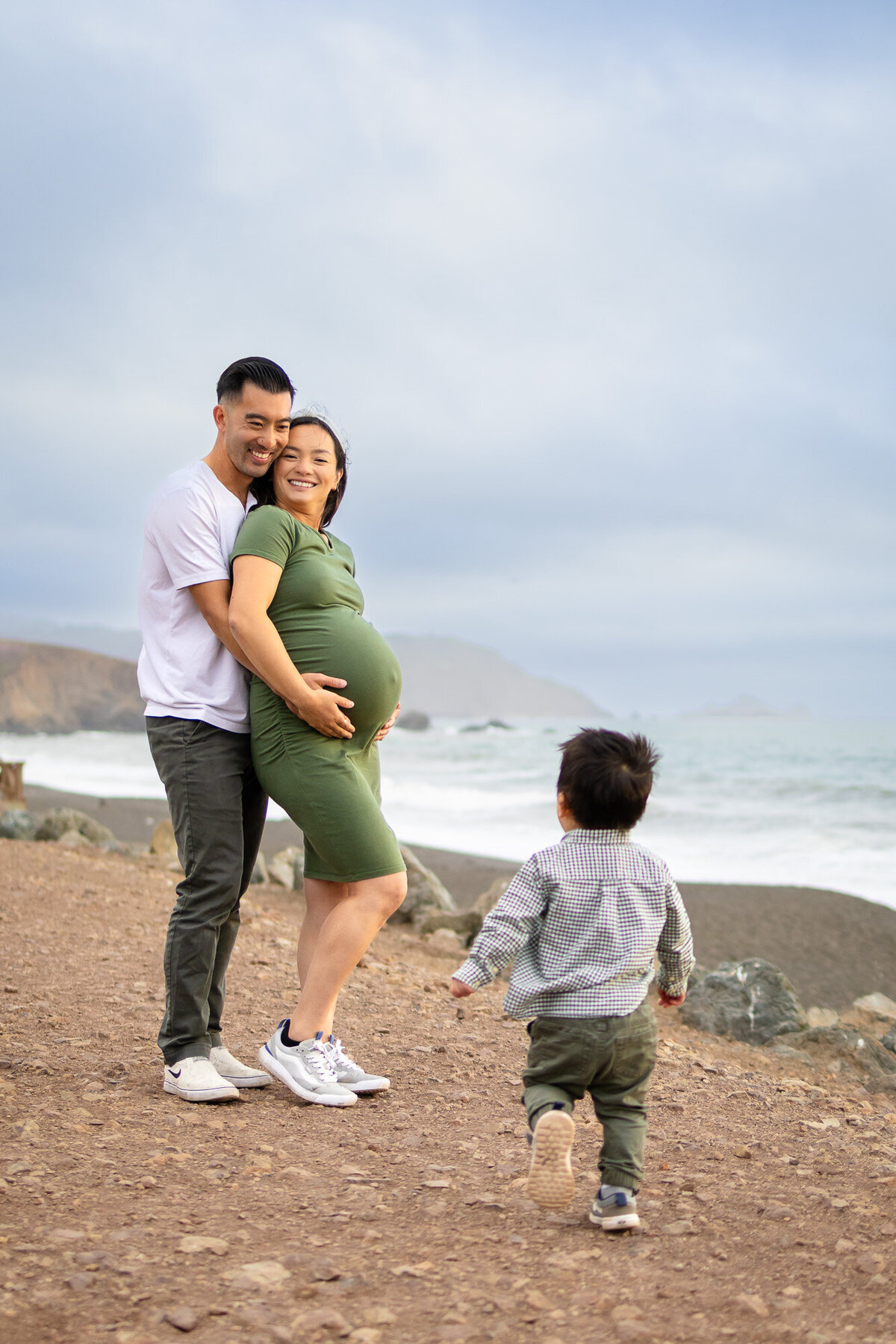 Bay Area Maternity Portfolio - Ellobelle Photography candid moment with toddler running toward parents on the coast