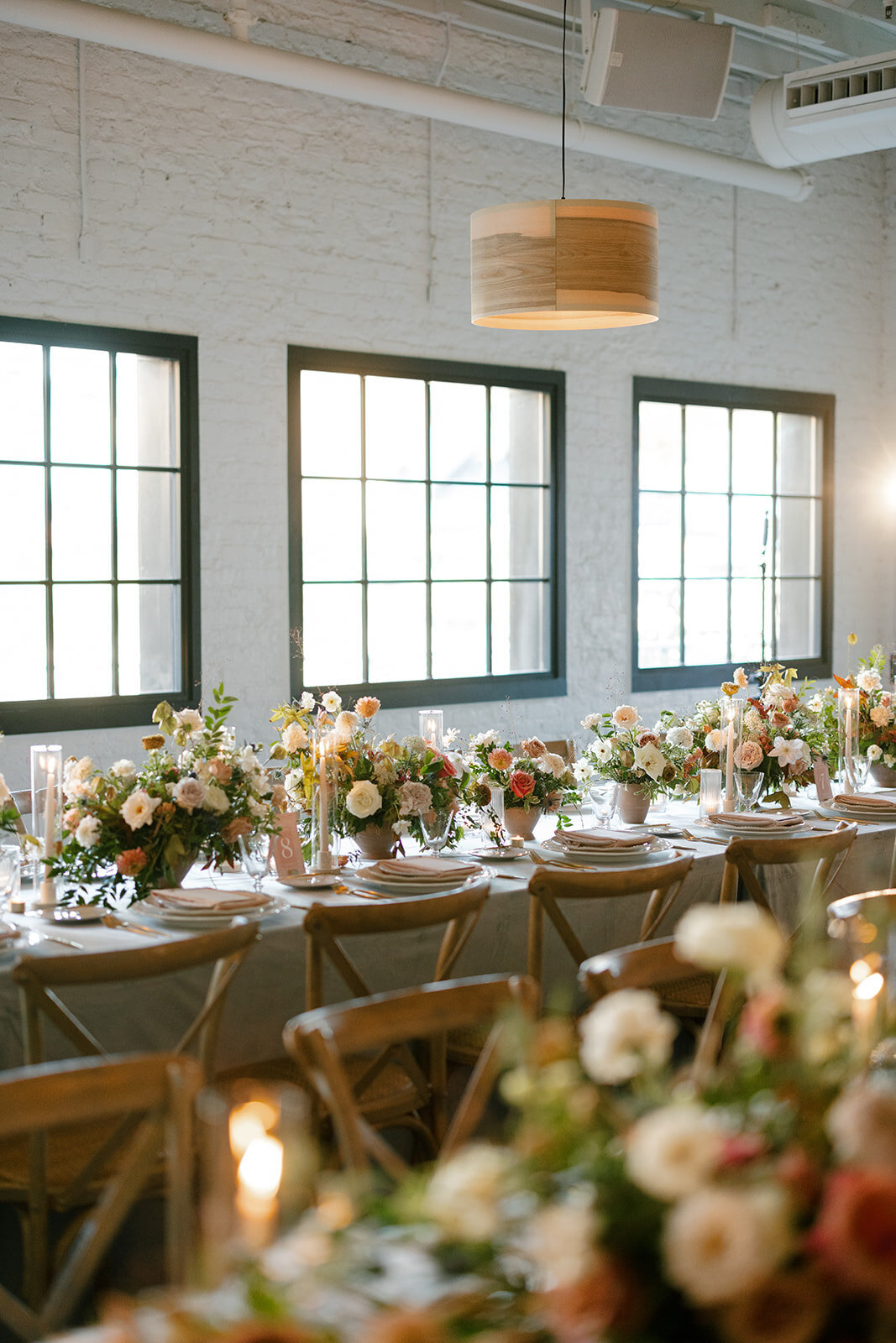 Fall wedding in Raleigh, NC highlights the beautiful autumnal setting in the Carolinas. Floral colors of copper, terra cotta, dusty pink, mauve, dusty blue, taupe, cream, and natural green. Flowers consisting of roses, dahlias, ranunculus, thistle, rain tree pods, and fall branches. Design by Rosemary and Finch Floral Design based in Nashville, TN.