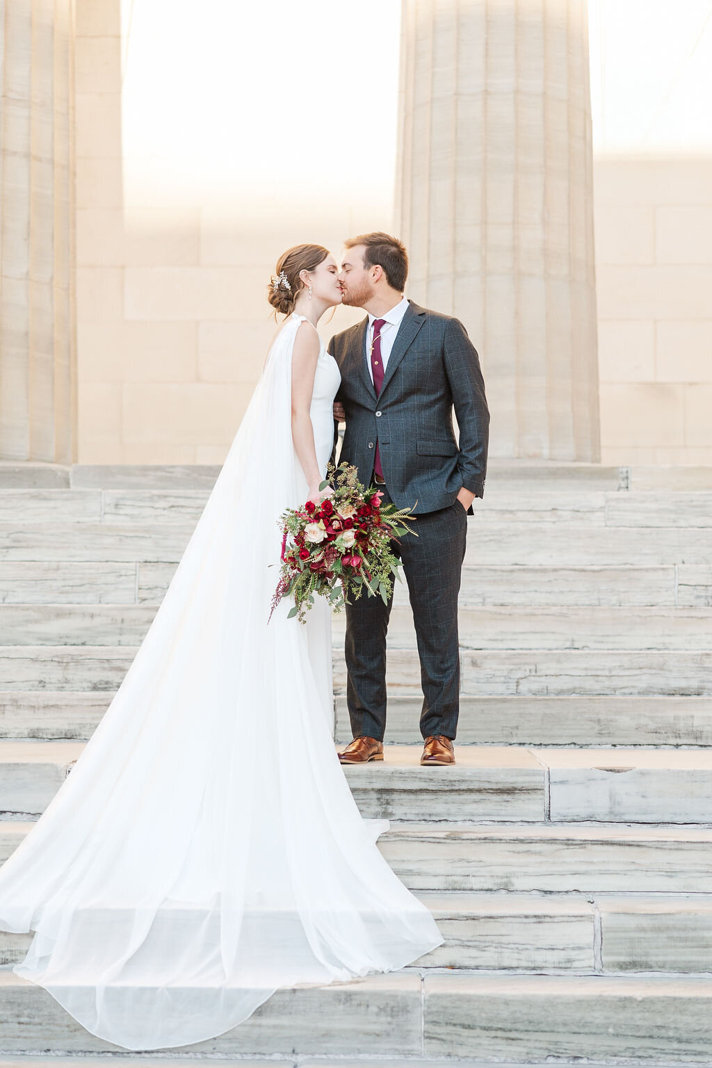 Photo of Bride and Groom  kissing on staircase
