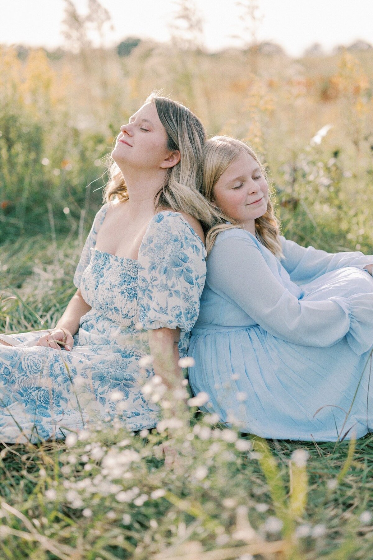 mom-and-daughter-sitting-back-to-back