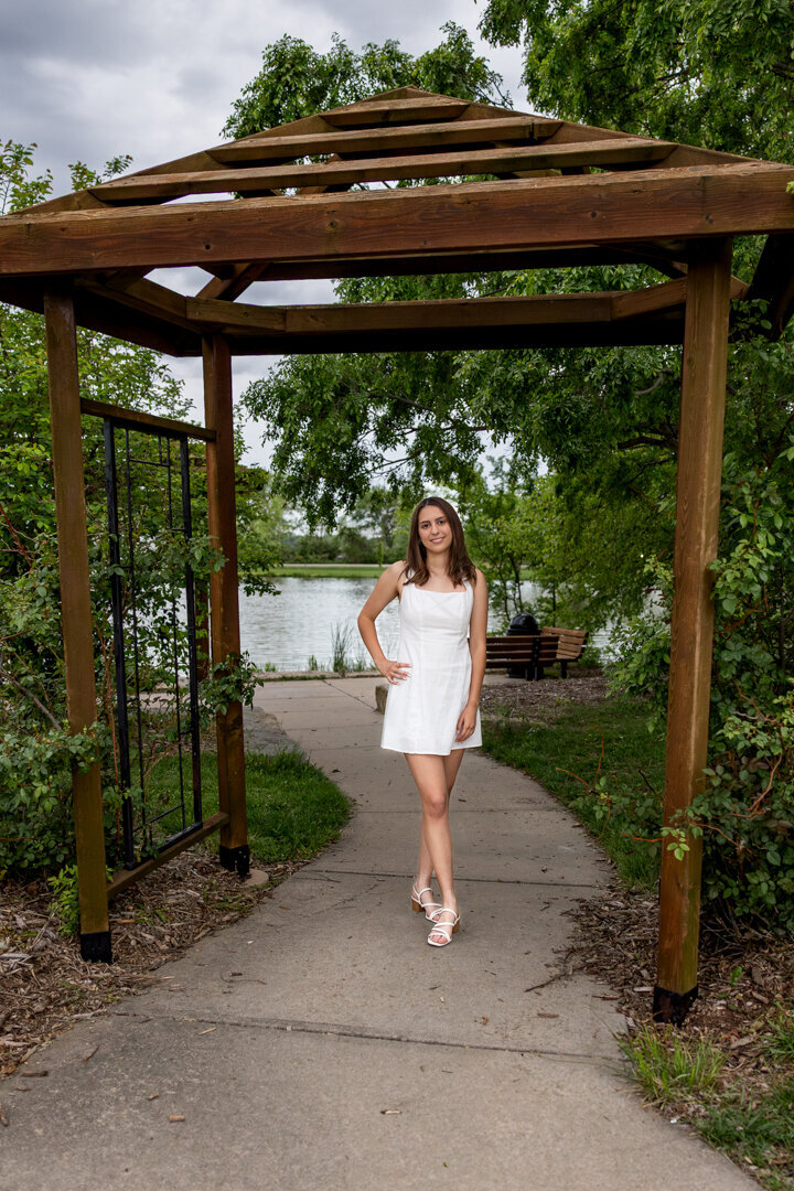 A senior girl standing under a gazebo  in Lawrence KS